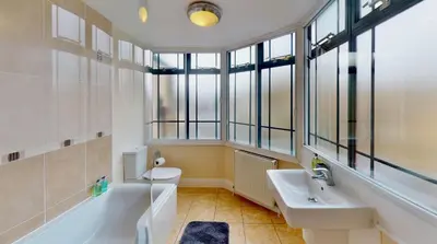 a bathroom with a sink and a tub and a toilet at Niche Water Tower Apartments in Braintree
