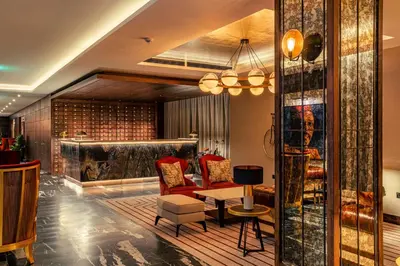 a living room with a couch and a table at The Fellows House Cambridge, Curio Collection By Hilton in Cambridge