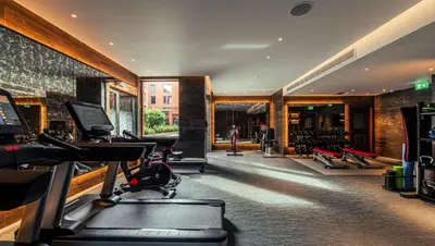 a gym with treadmills and exercise equipment in a building at The Fellows House Cambridge, Curio Collection By Hilton in Cambridge