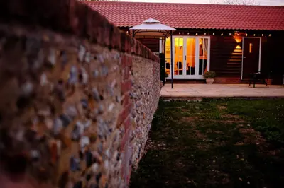 a brick wall in front of a house at Walnut Tree Cottage Barn in Toppesfield