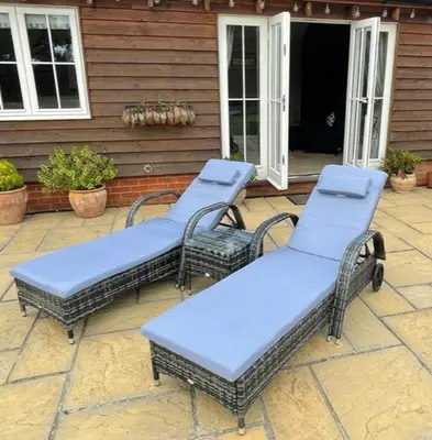 three wicker chairs sitting on a patio in front of a house at Walnut Tree Cottage Barn in Toppesfield