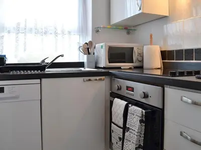 a kitchen with a sink and a microwave at Cottage - Sleeps 3 Parking & Fishing in Hilgay