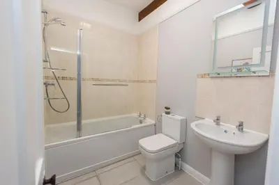 a bathroom with a toilet and a sink and a shower at NEW Bespoke 2 BED Town Centre Serviced Apartment in Ipswich