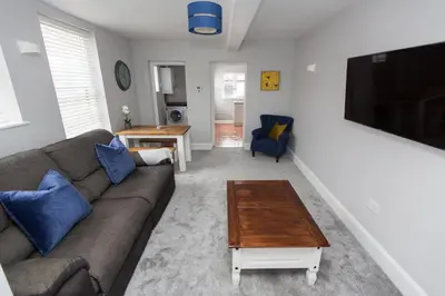 a living room with a couch and a coffee table at NEW Bespoke 2 BED Town Centre Serviced Apartment in Ipswich