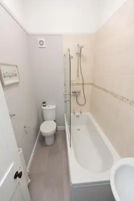 a bathroom with a tub and a toilet and a sink at NEW Bespoke 2 BED Town Centre Serviced Apartment in Ipswich