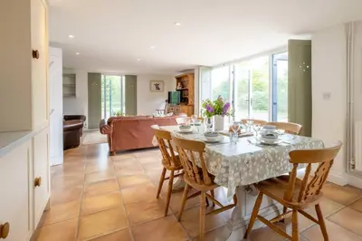 a dining room with a table and chairs at East Green Farm Cottages - The Dairy in Saxmundham