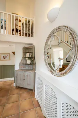a large mirror on a wall in a room at East Green Farm Cottages - The Dairy in Saxmundham
