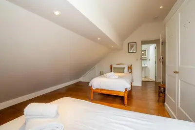 a bedroom with a bed in a attic at East Green Farm Cottages - The Dairy in Saxmundham