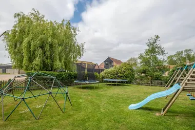 a playground with two swings and a slide at East Green Farm Cottages - The Dairy in Saxmundham