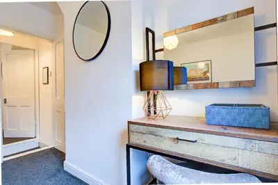 a mirror on a wall above a dresser in a room at Free Parking Business Stay Office Fast WiFi in Colchester