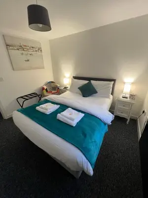 a bedroom with a bed with two towels on it at Mayland Motel in Mayland