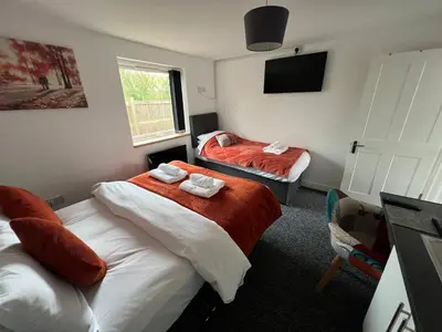 a hotel room with two beds and a tv at Mayland Motel in Mayland