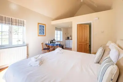 a bedroom with a large white bed in a room at 6 Lakeside Avenue in Thorpeness
