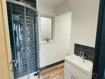 a bathroom with a glass shower and a sink at Warren Lodge in Little Baddow