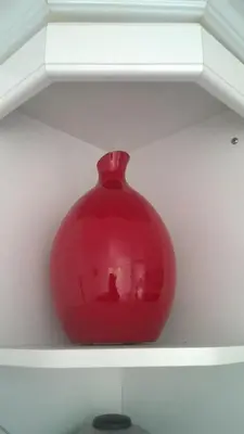 a red vase sitting on top of a shelf at Chauffeur's, Snape in Saxmundham
