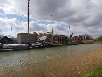 a couple of boats are docked in a river at Chauffeur's, Snape in Saxmundham