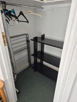 a closet with a black shelf and a table at Chauffeur's, Snape in Saxmundham