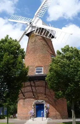 a windmill with a blue door in front of it at Station Heights in Rayleigh