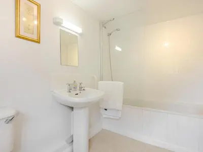 a white bathroom with a sink and a shower at Coach House - Uk33307 in Mellis