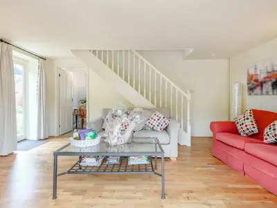 a living room with a red couch and a table at Coach House - Uk33307 in Mellis