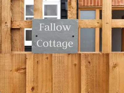 a sign on a wooden fence that reads hallowate at Fallow Cottage - Uk33488 in Hadleigh