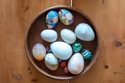 a bowl full of easter eggs on a wooden table at The Stables, Theberton in Theberton