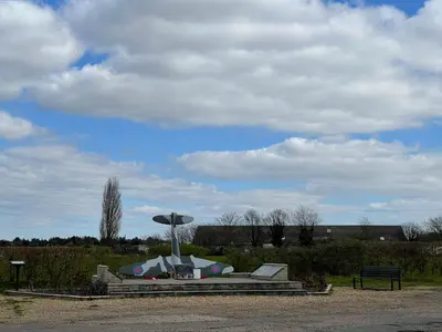 a statue in a park with a bench at The Cow Shed - Sleeps 4 Parking & Pet Friendly in Bradwell on Sea