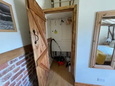 a door leading into a room with a bed at The Cow Shed - Sleeps 4 Parking & Pet Friendly in Bradwell on Sea