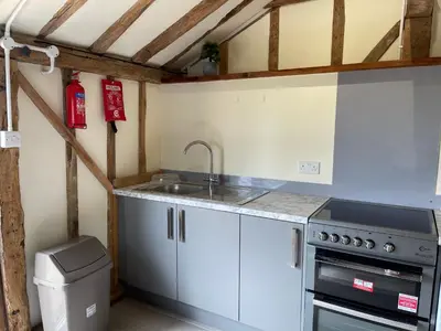 a kitchen with a sink and a stove at The Cow Shed - Sleeps 4 Parking & Pet Friendly in Bradwell on Sea