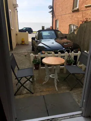 a table and two chairs and a table and a car at Sea view studio in Felixstowe