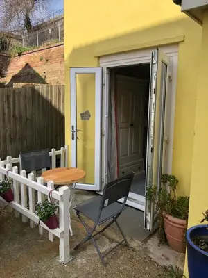 a table and chairs in front of a house at Sea view studio in Felixstowe