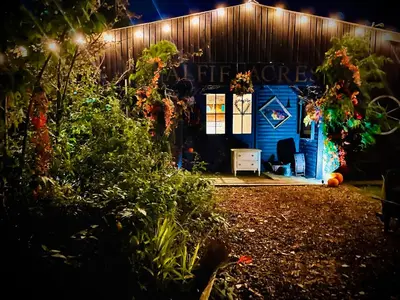 a blue shed with a sign that says home depot at Alfie Acres - Secluded Cabin set in 5 Acres of Privacy, with Exclusive use of Swimming Pool and Hot Tub for up to 10 Guests in Downham
