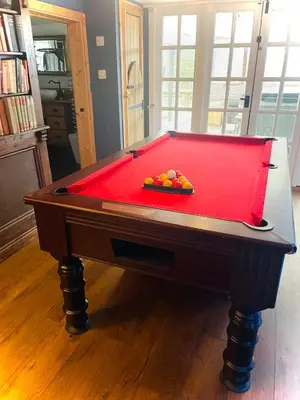 a pool table with a red cover in a room at Alfie Acres - Secluded Cabin set in 5 Acres of Privacy, with Exclusive use of Swimming Pool and Hot Tub for up to 10 Guests in Downham
