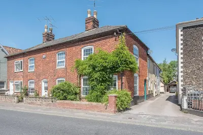a red brick building with ivy growing on it at Abigail's Cottage, Wickham Market in Woodbridge