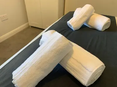 two wrapped up socks on top of a bed at Eclipse Apartment No 4 in Newmarket