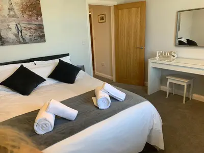 a hotel room with a bed with towels on it at Eclipse Apartment No 4 in Newmarket