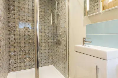 a bathroom with a shower and a sink at Breckland Cottage - Secluded Country Getaway in Hockwold cum Wilton