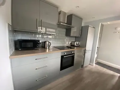a kitchen with a microwave oven and a refrigerator at Eclipse Apartment No 3 in Newmarket