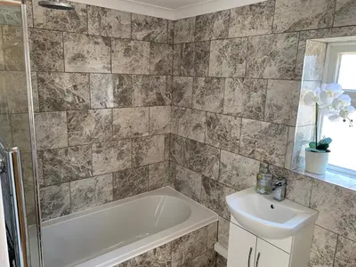 a bathroom with a tub and a sink at Eclipse Apartment No 3 in Newmarket