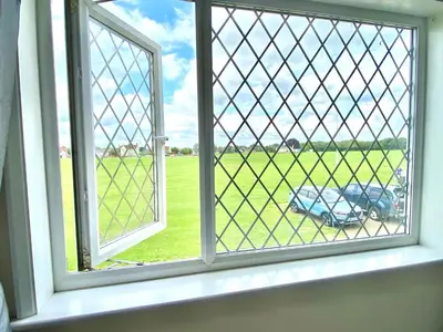 an open window with a view of a field at Cosy Cottage Great Bentley near station and shops in Great Bentley