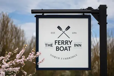 a sign for the ferry boat inn with pink flowers at The Ferry Boat Inn in North Fambridge