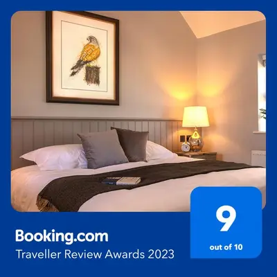 a bedroom with a bed with a picture of a bird at The Ferry Boat Inn in North Fambridge