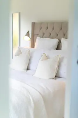 a white bed with white sheets and pillows at The Nook in West Mersea