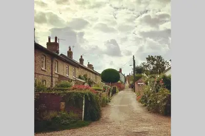 a dirt road in a small village with houses at Melford Allotment Shed-Vintage Lodge Suffolk in Long Melford