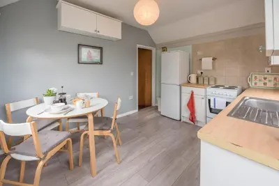 a kitchen and dining room with a table and chairs at Suncatch Corner, Saxmundham in Saxmundham