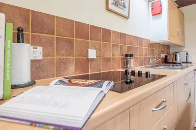a kitchen with a counter with a sink and a counter sidx sidx at The Stables, Valley Farm, Snape in Saxmundham