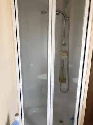 a bathroom with a shower and a toilet at Tref y Clawdd in Felixstowe