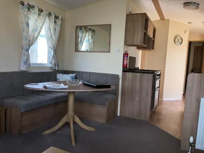 a living room with a couch and a table at Tref y Clawdd in Felixstowe