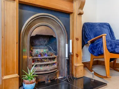 a living room with a fire place in a room at Mayflower Cottage in Harwich