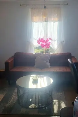 a living room with a couch and a coffee table at Elegant 2 BR Apartment in Historic Cambridge in Papworth Everard